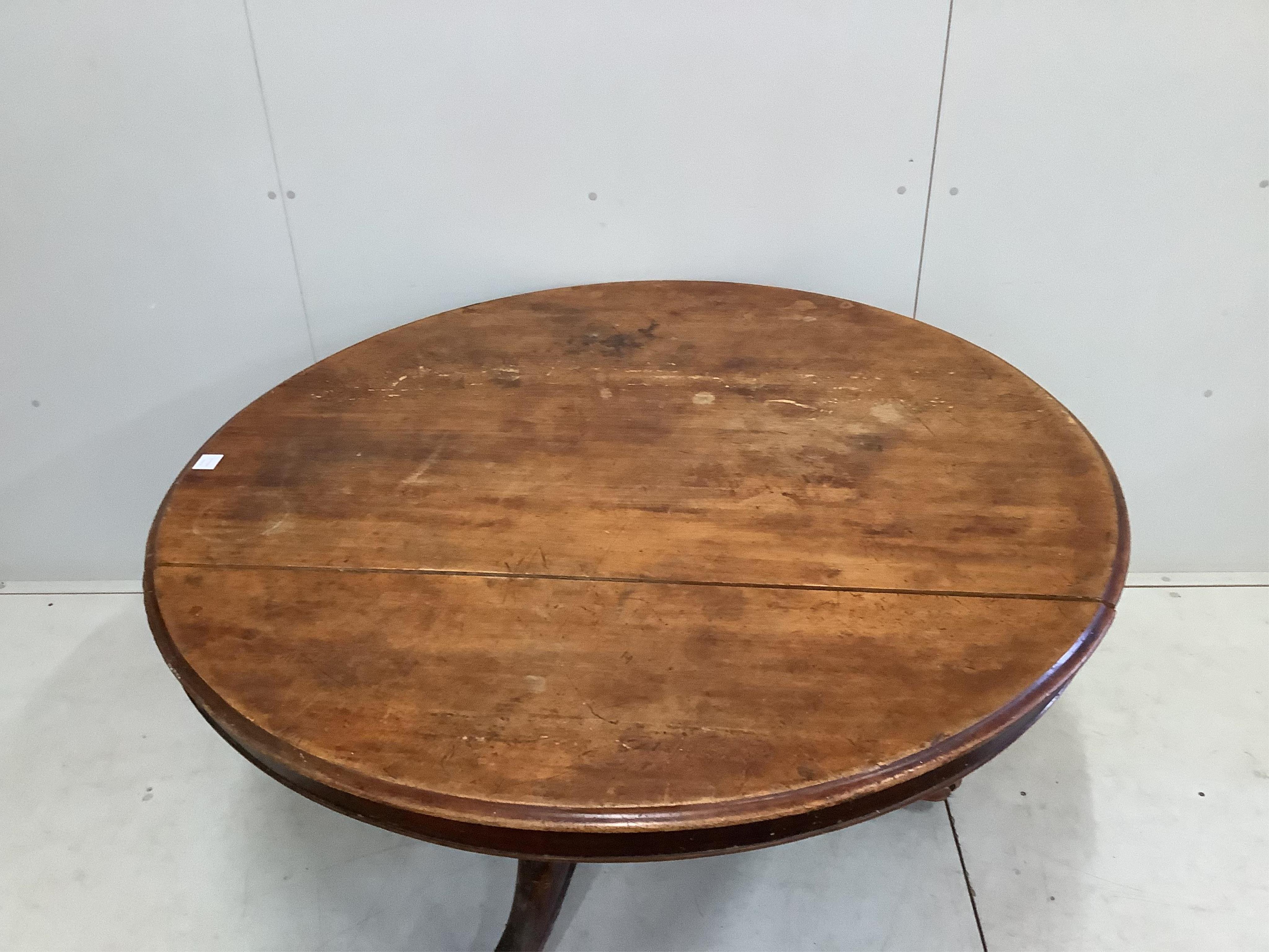 A Victorian circular mahogany tilt top tripod breakfast table with claw feet, diameter 136cm, height 72cm. Condition - poor